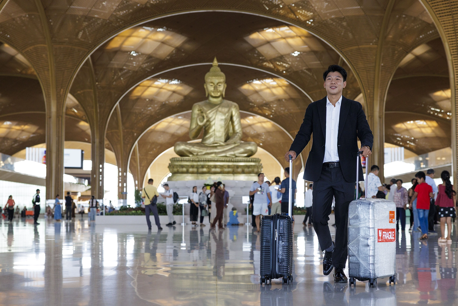 Man with wrapped suitcase at Techo airport Cambodia