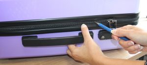 Opening suitcase with a pen